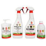 A set of four Botanica brand grooming products, including bottles labeled 'MANE & TAIL 6-in-1', 'FLY SPRAY', and 'Natural Herbal Cream'. Each bottle has a white body with red and green text and accents.